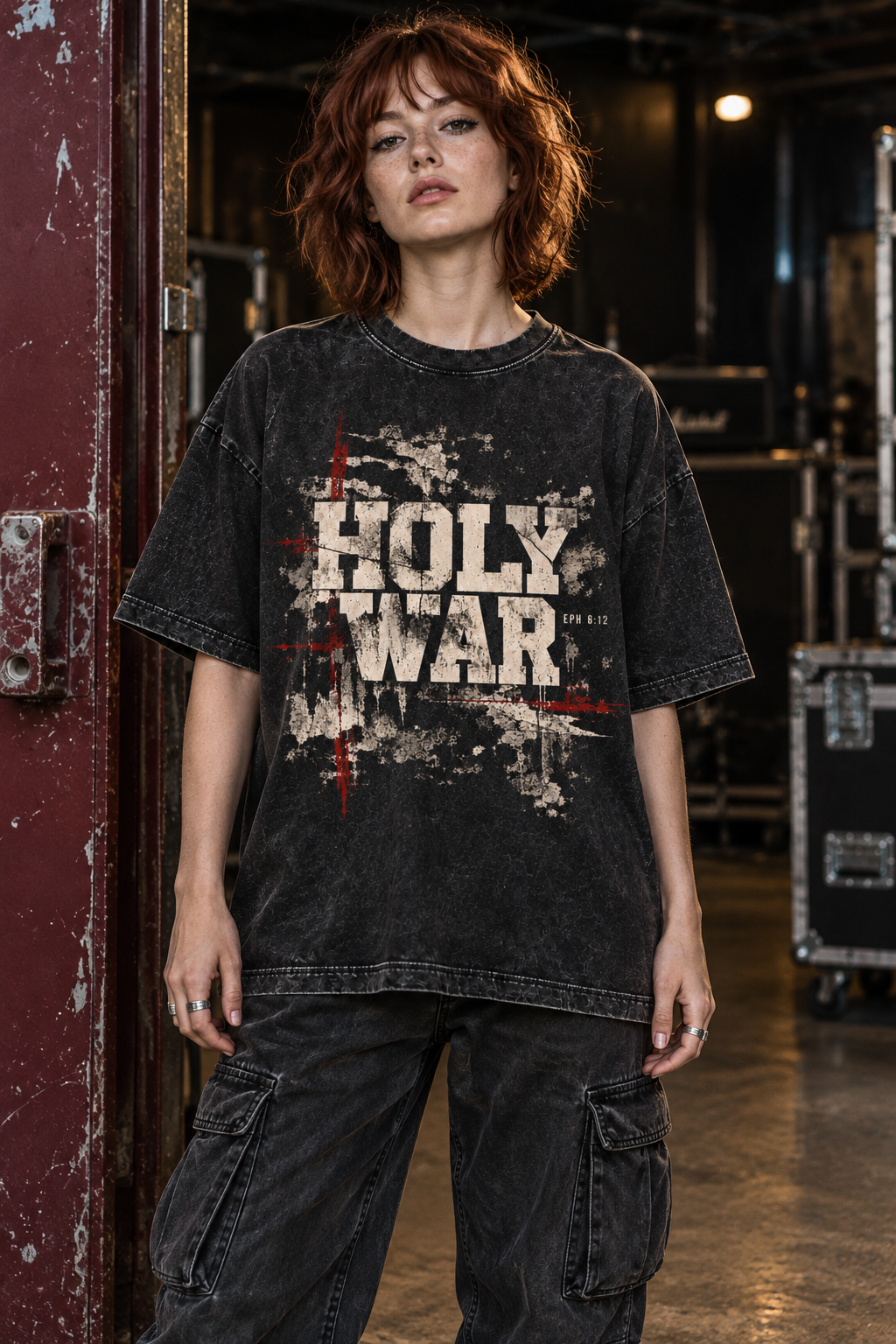 Woman backstage at a venue wearing the Holy War tee
