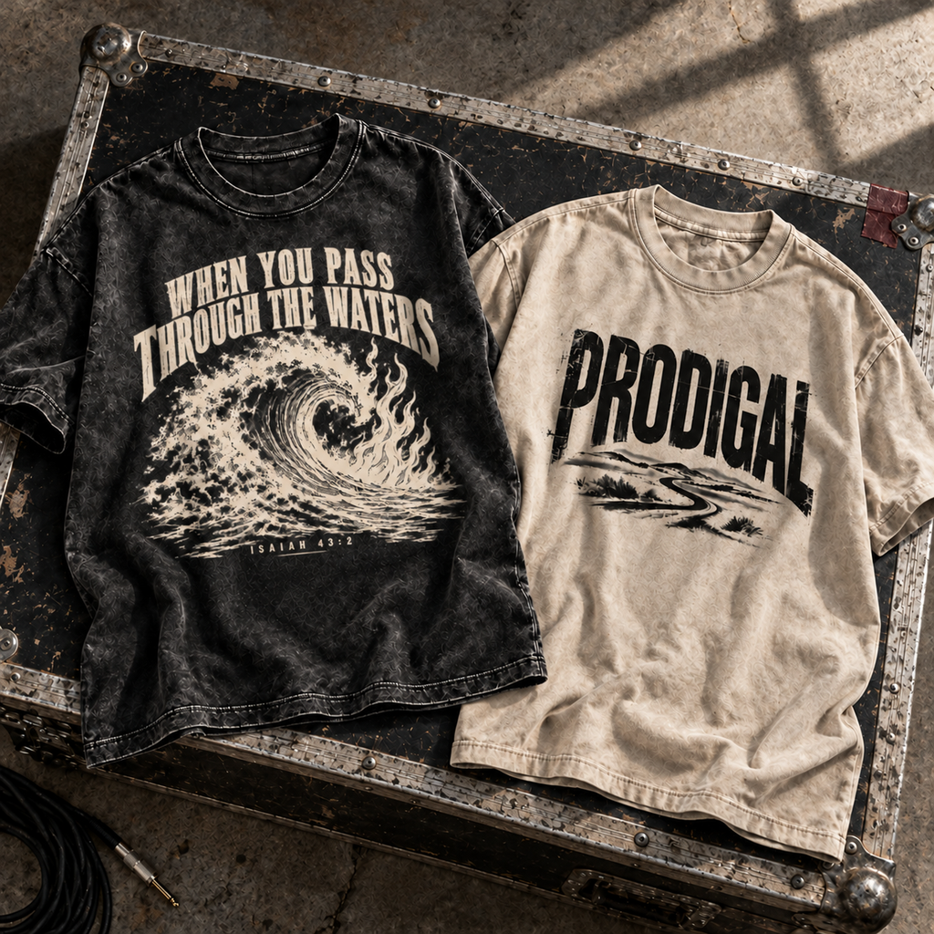 Prodigal and Through the Waters tees laid flat on a road case